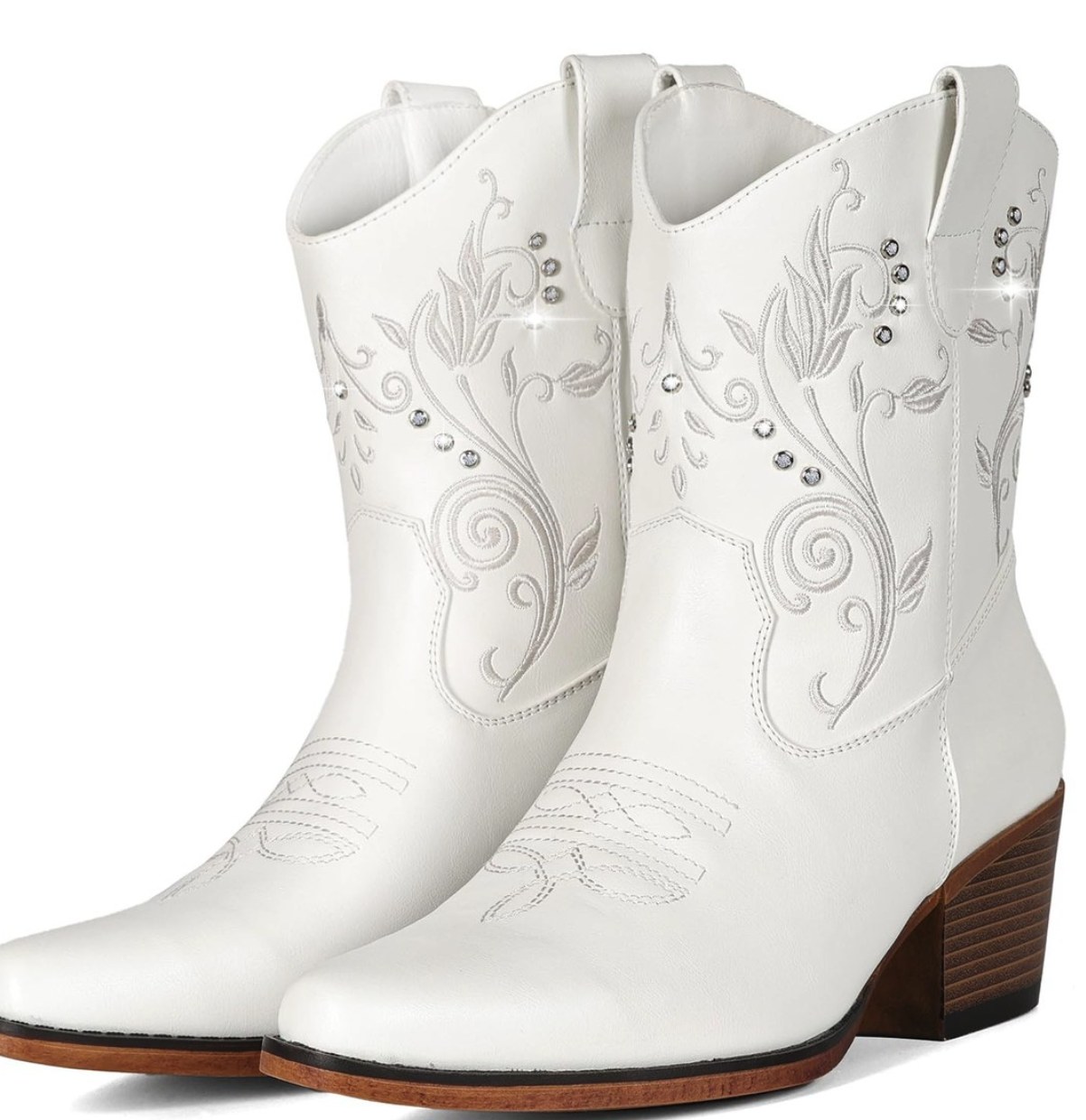 White cowgirl boots with floral embroidery, rhinestone accents, pointed toe, and stacked block heel